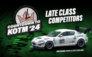 White Mazda RX-8 race car with various sponsor decals, featuring the text "Countdown to KOTM '24," "Late Class Competitors," and "Sam Strano, KOTM 5.0 Late Class King" on a green background.