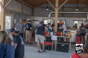 A group of people standing around in a barn.