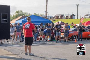 A man is standing in front of a crowd of people.
