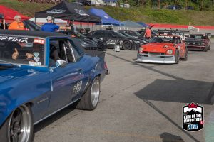 A group of cars parked in a parking lot.
