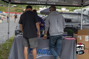 A group of people standing under a tent.