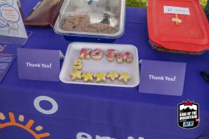 A table full of cookies with a thank you sign on it.