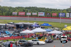 A group of cars parked at a race track.
