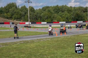 A group of people riding motorcycles on a track.