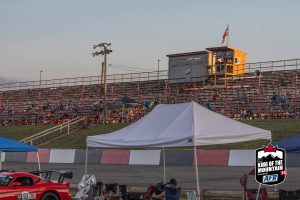 A race track with a tent and spectators.