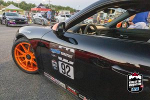 A black porsche 911 gtr parked in a parking lot.