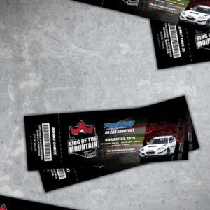 Two event tickets for "King of the Mountain" car shootout on August 23, 2025, featuring a white race car, are placed on a gray surface.