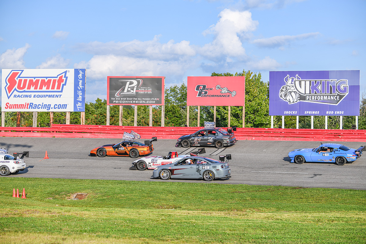 A group of cars on a race track.